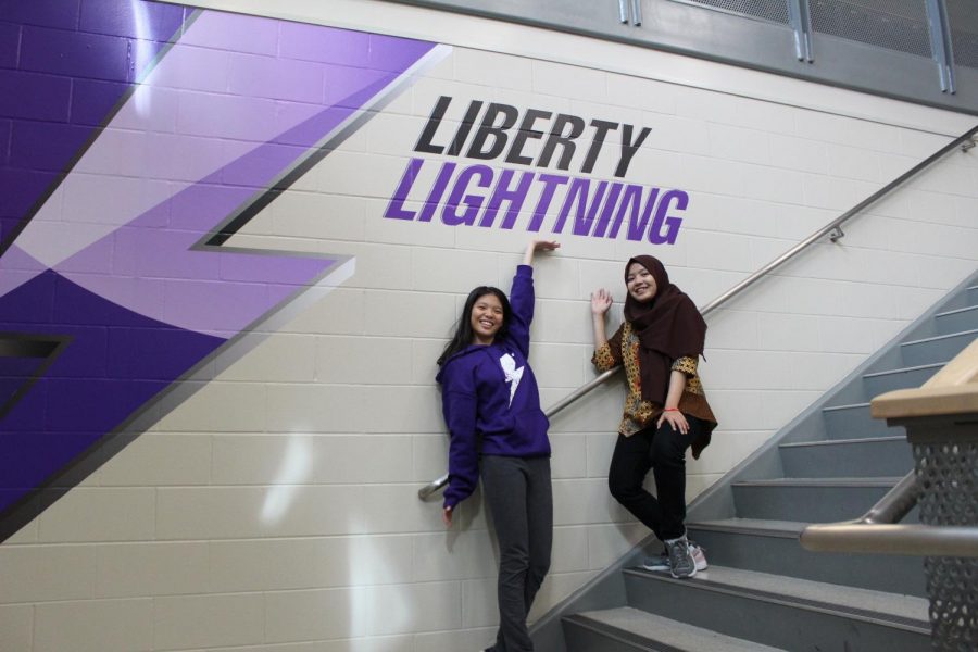 Ifada Auzan and Lavinia Wu posing in the staircase in the academic commons. 