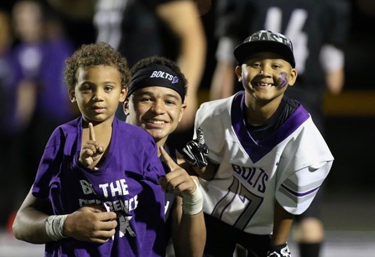 Kaleb poses for a picture with Aidan and his brother. After the 2018 Mid-Prairie game. 