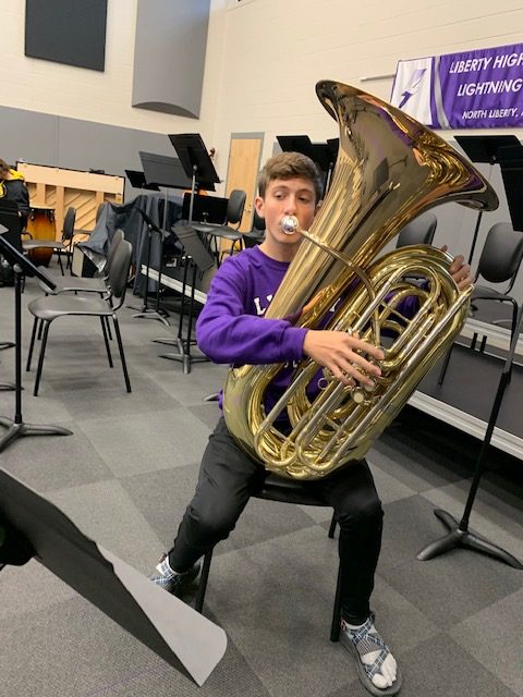 Tyson Baker practices music in the band room.