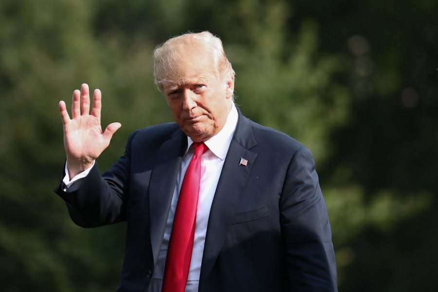 President Donald Trump waves as he returns to  the White House on Aug. 19, 2018. 