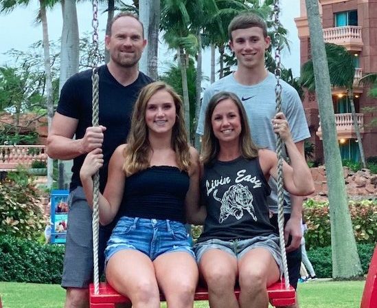 The Woody family, Joey, Isabelle, Heather, and Drake, pose for a family photo in the Bahamas.