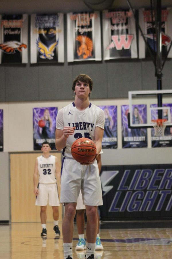 Kelby Telander shoots a free throw in a home basketball game against City High School