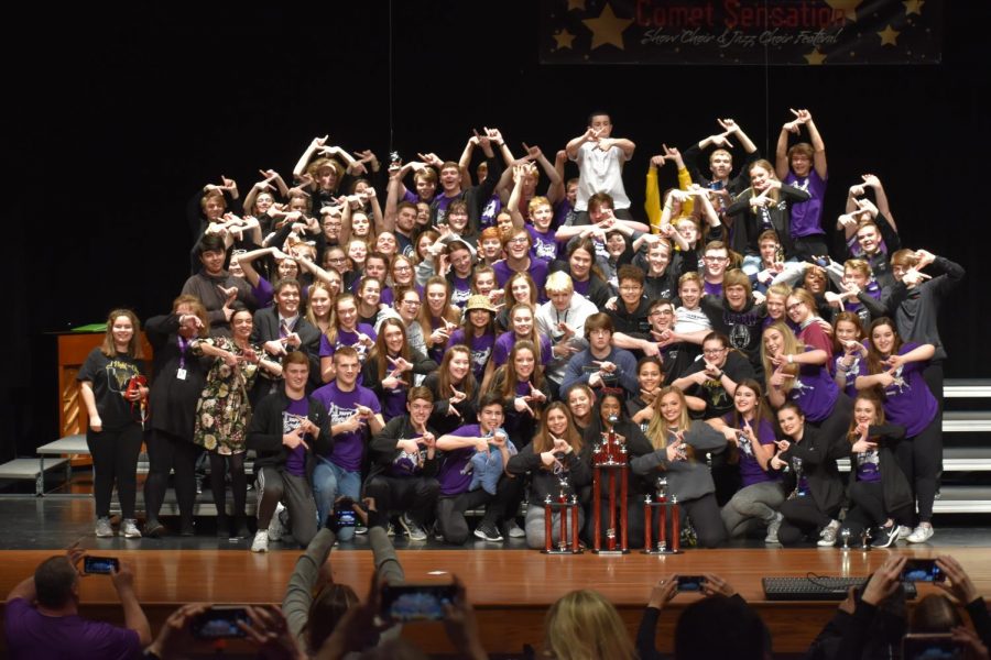 Members of show choir pose with their trophies after storming the awards stage at North Polk High School.