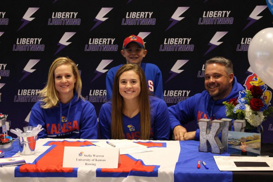 Stella Warren signing her Letter of Intent with her parents and little brother. 