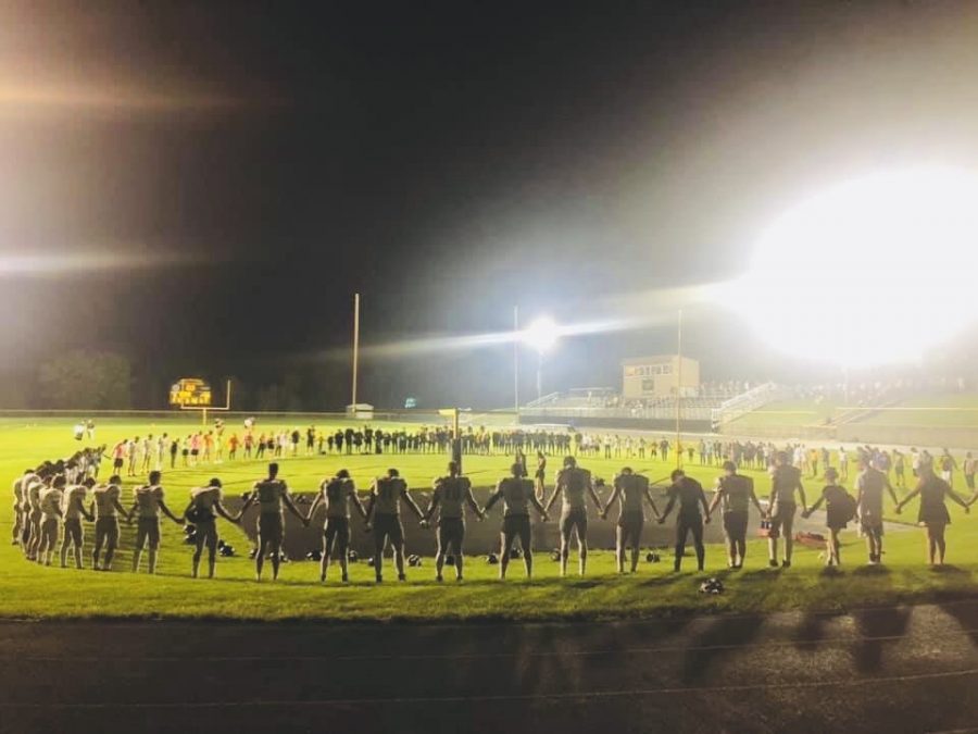 A group prayer after the football game vs Mid Prairie on 9-20-19