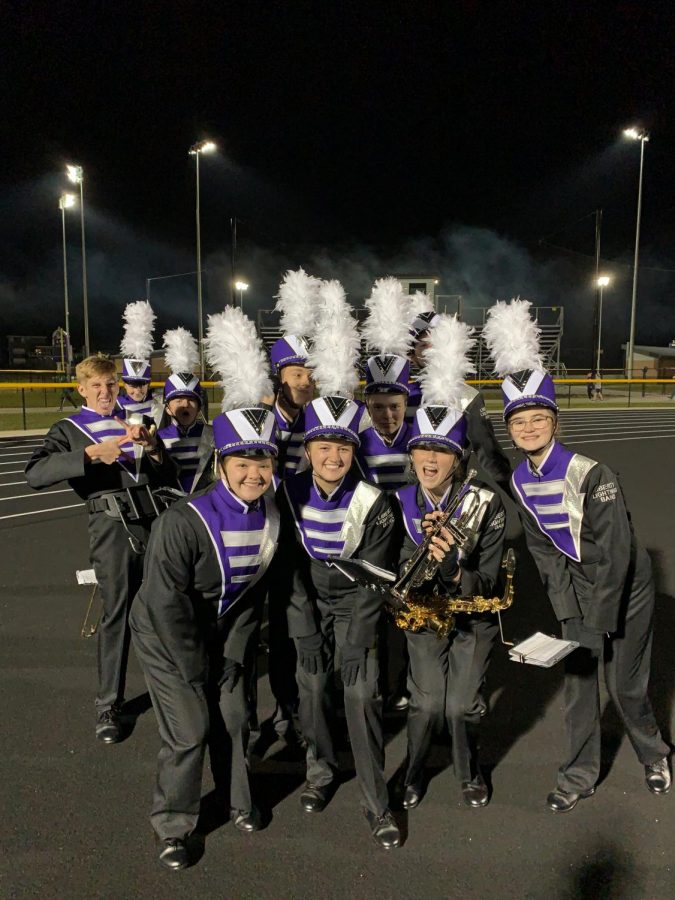 Gabby Brecht and her friends pose for the camera after marching in a 2019 Liberty football game.