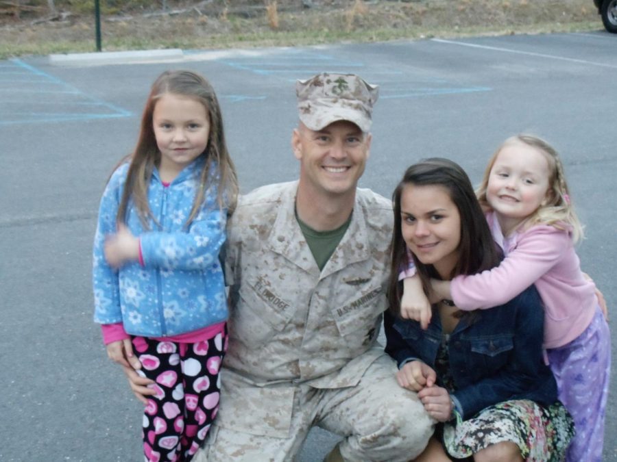 Erik Eldridge comes home and is welcomed by his daughters.