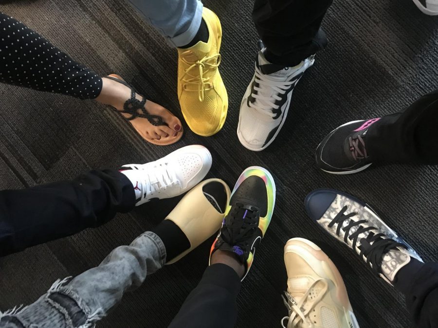 English Language Learners (ELL) students at Liberty show off their shoes, along with their teachers.