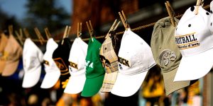 Photo displaying many of the University of Iowa hat styles that many students wear. 