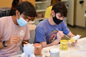 Two Liberty seniors working on their ceramics projects in ceramics class. 