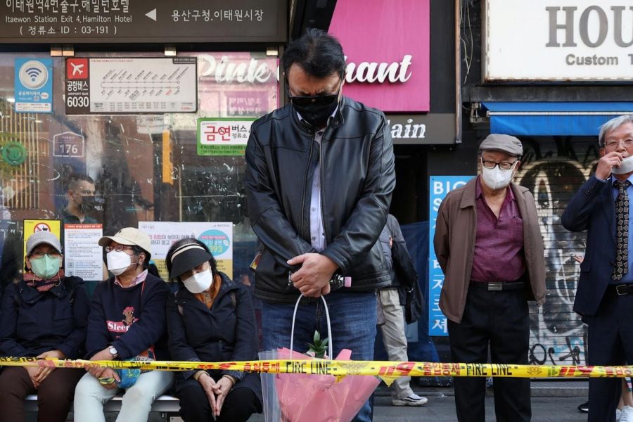 A man grieves near the scene where over 156 deaths occurred in Itaewon.