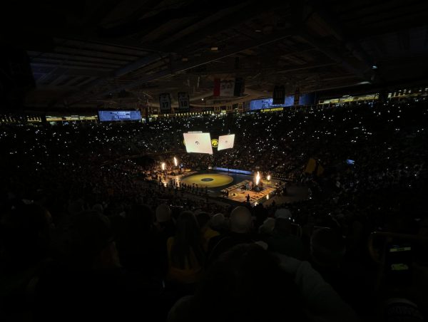 Carver Hawkeye Arena, sold out for a wrestling match against Pennsylvania State University, flooded with Hawkeye fans.