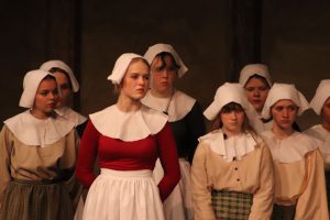 Students from the Liberty Lightning Theater perform in the play “The Crucible,” showcasing the intense atmosphere of the Salem Witch Trials.