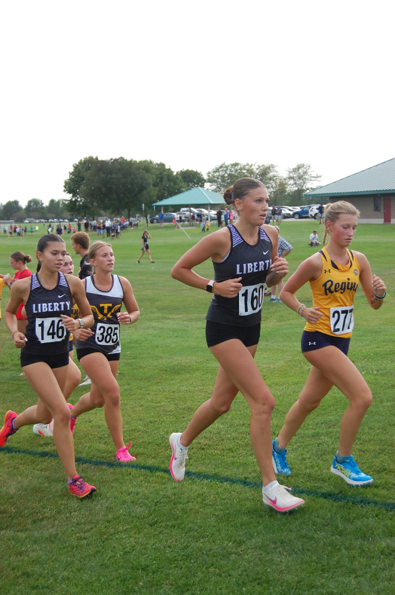 Marrissa Becker, 12 and Carleigh Maher, 11 make a stride for the finish line at a competitive meet. 