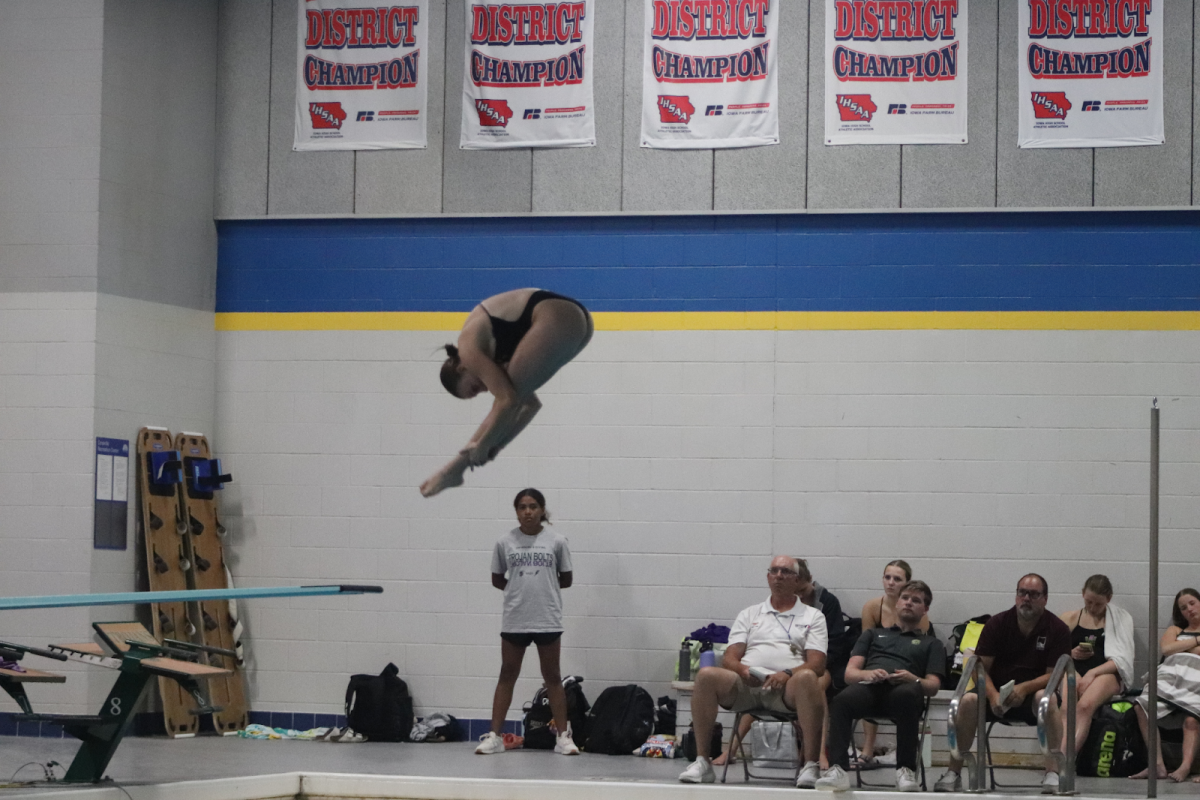 Kamila Swanson, 12 leaps into the air as she dives into the water. 